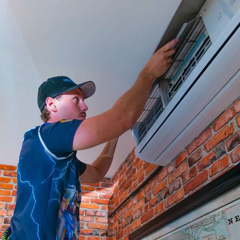 Electrician working on air conditioning